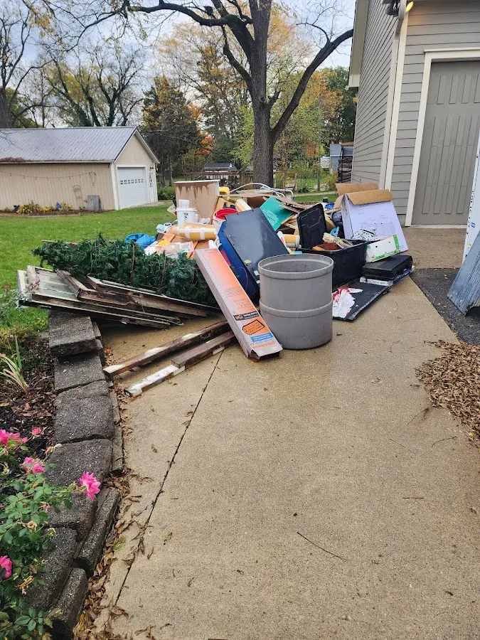 Dumpster being loaded with debris for 10 Yard Dumpster Rental in Moore